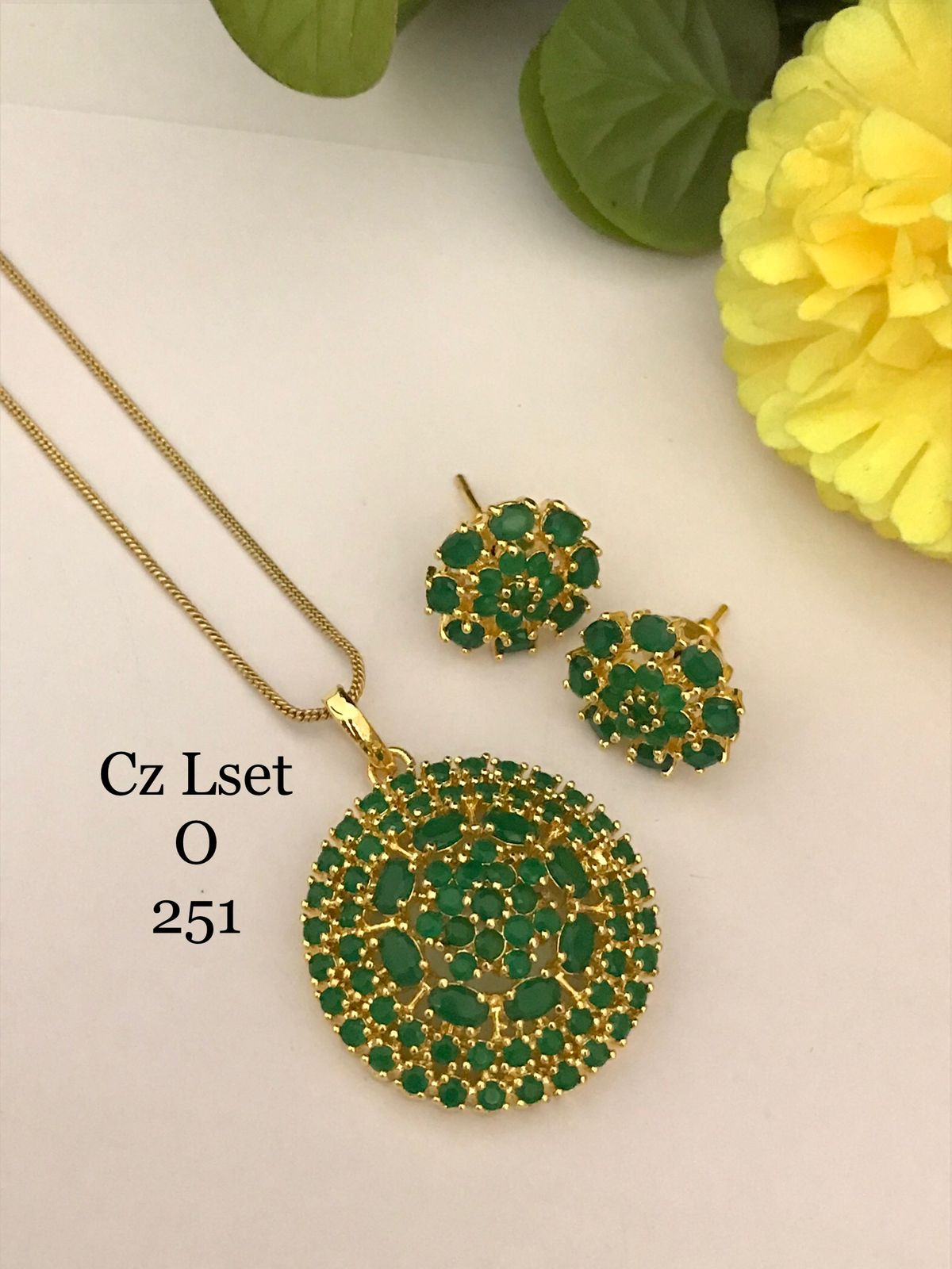 Green stone studded Gold finish Ganesha Pendant with Earrings set