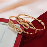 A Pair of artificial gold and  Diamond Bow Openable Bangles for kids