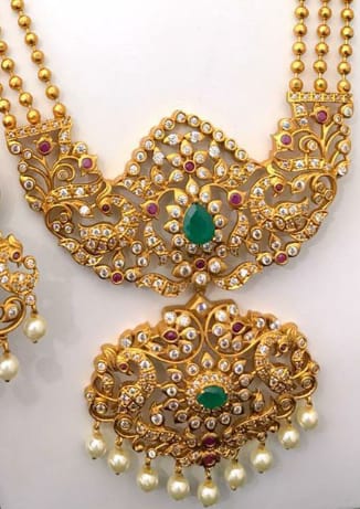 Temple Jewellery Multi Strand Pearl Mala Ruby Emerald Laxmi Gold Pendant and earrings