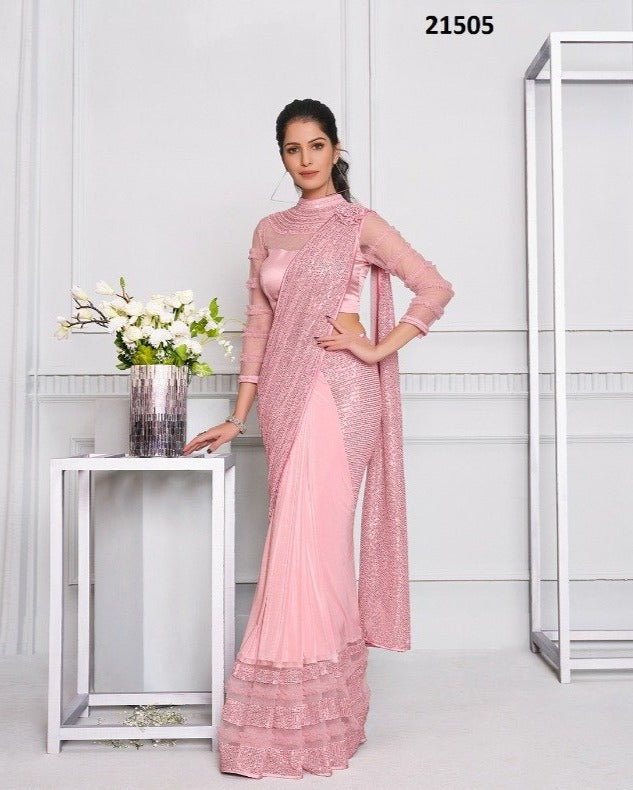 pink saree dress Sequined Blush pink Saree-Style Gown: This ensemble features a heavily embellished lavender or dusty rose fabric with intricate sequin work. The blouse has cold-shoulder sleeves adorned with delicate beaded fringe, while the