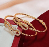 A Pair of artificial gold and  Diamond Bow Openable Bangles for kids